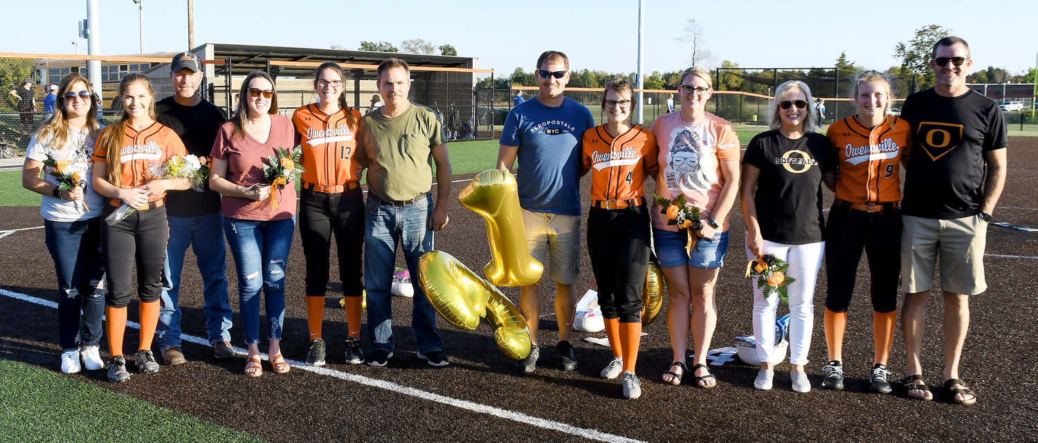 Owensville Dutchgirl softball seniors (above) and their families lined up for a group photo following Owensville’s 15-0 senior-night victory last Tuesday over Hermann’s Lady Bearcats at OHS Field. Seniors (above, from left) recognized after the game include Addison Wright, Leah Reed, Paige Loyd and Anna Finley.